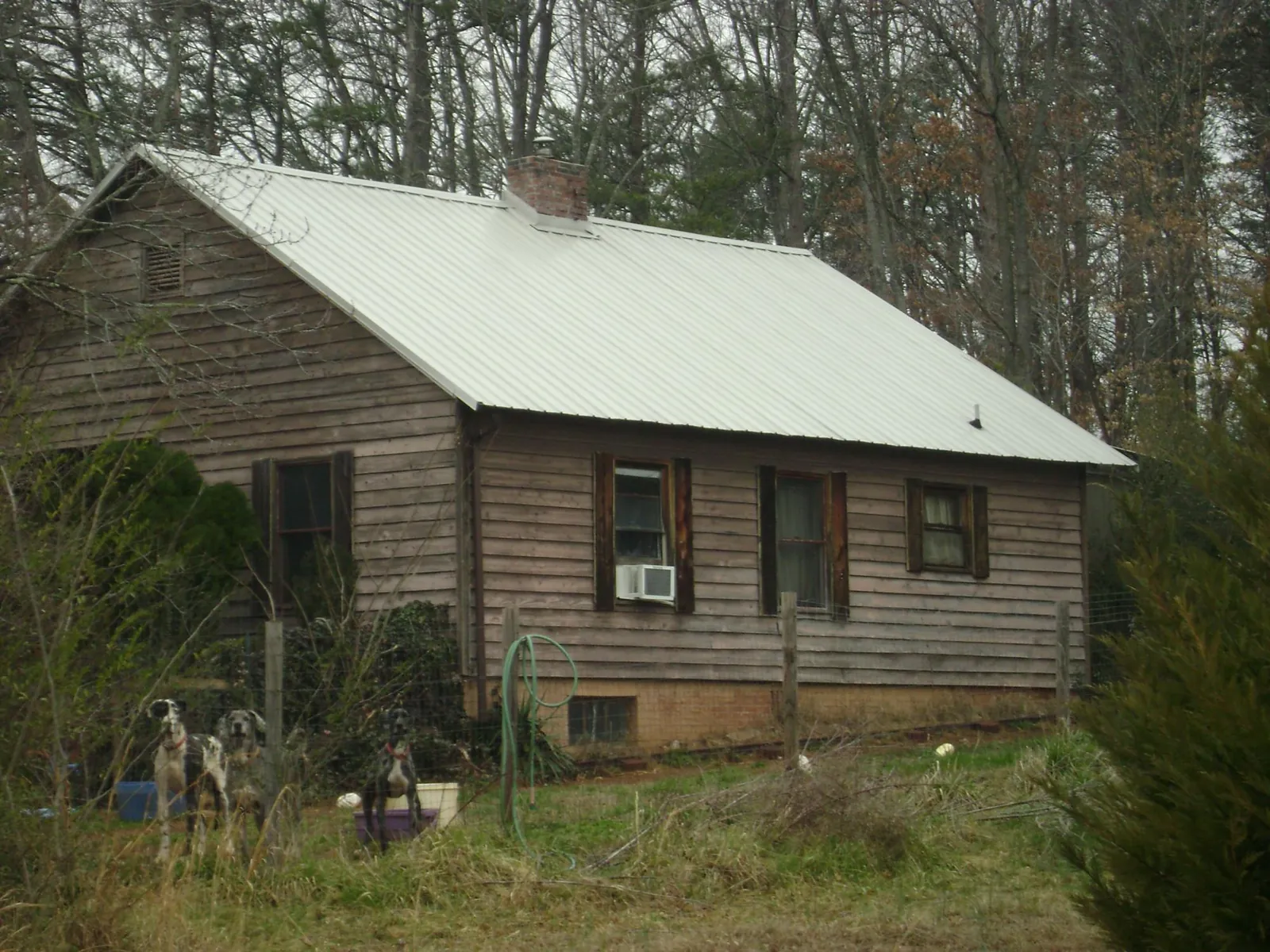 White metal roof on an old wood sided farmhouse, from a Metal Roof Installation job in Cordesville